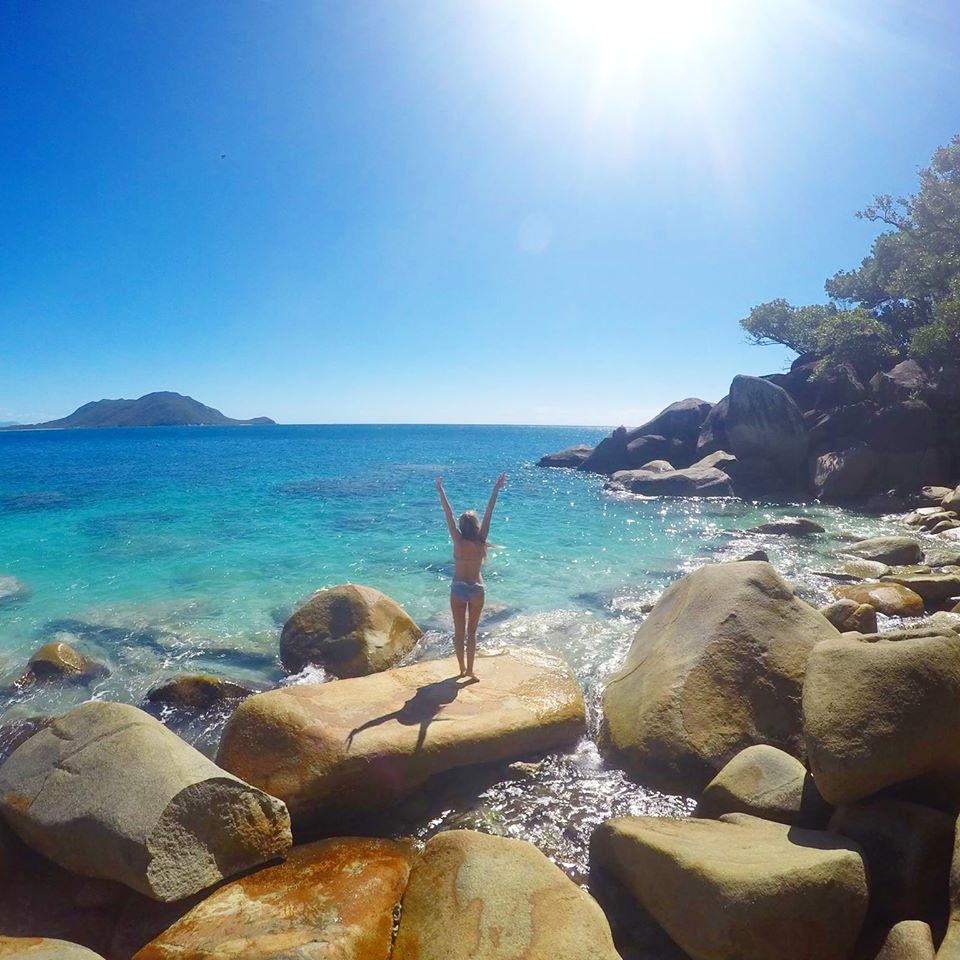 Girl standing on rocks at Nudey Beach in Fitzroy Island