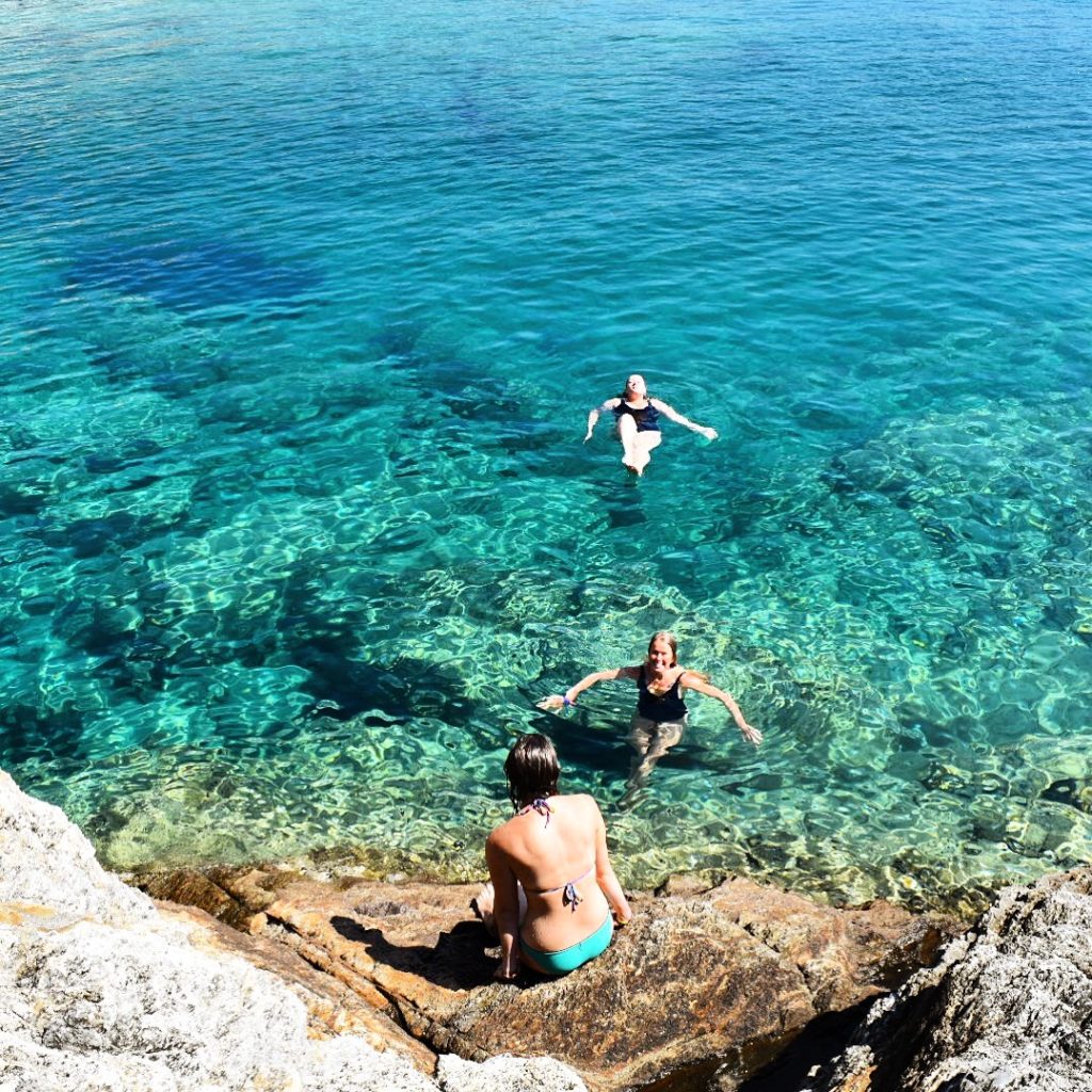 girls swimming in ocean in Ios Greece