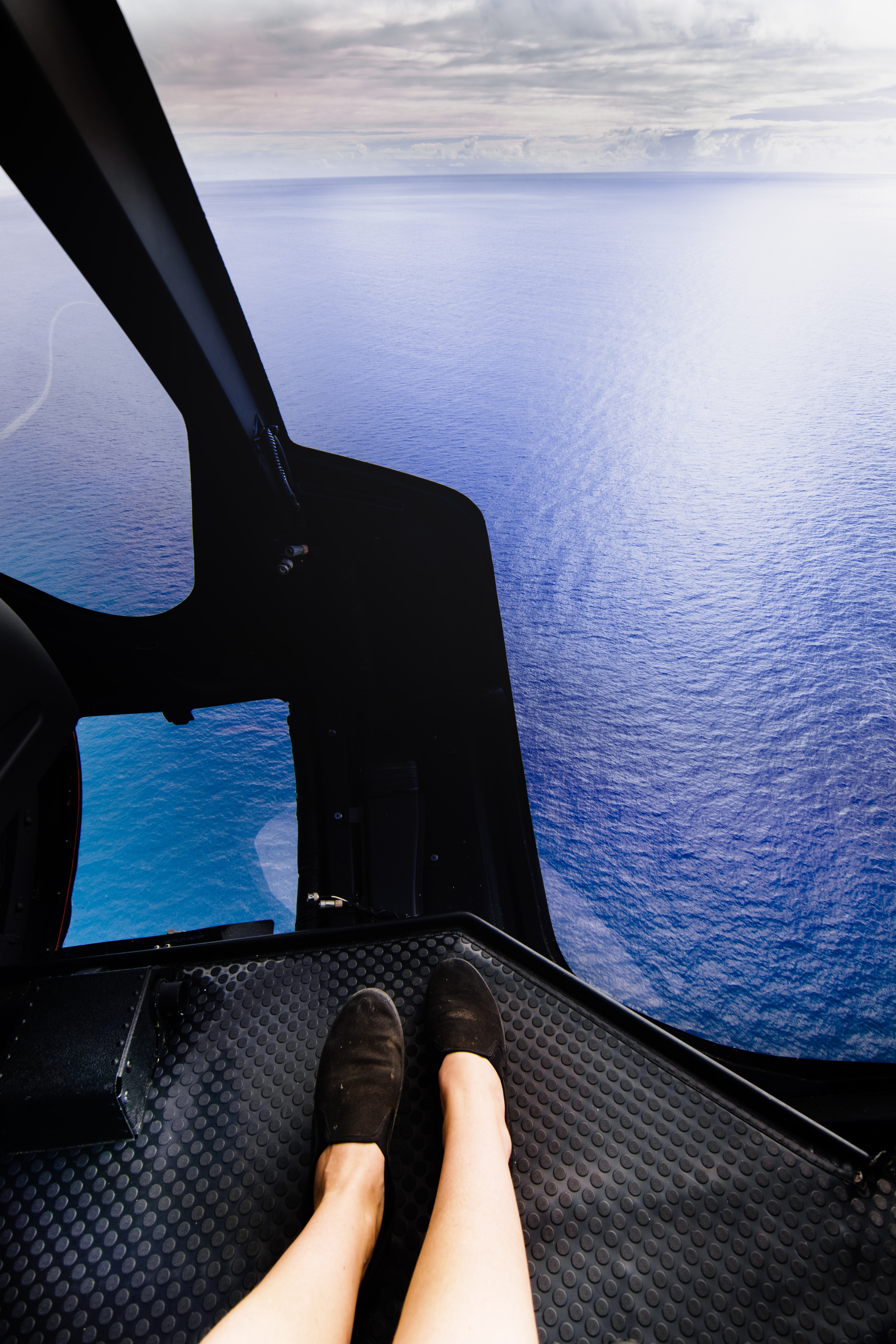 Feet in helicopter above the ocean