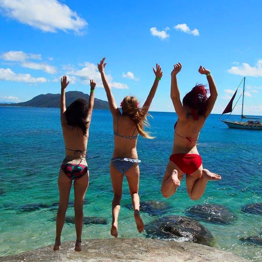 3 Girls jumping at Fitzroy Island near Cairns