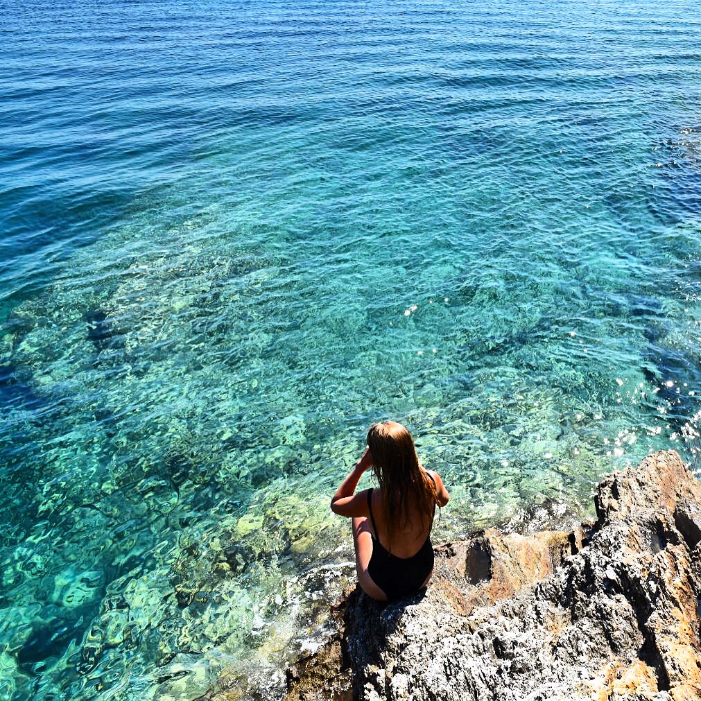 girl next to ocean in Ios, Greece