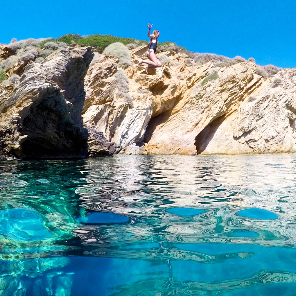 girl jumping into ocean Ios Greece