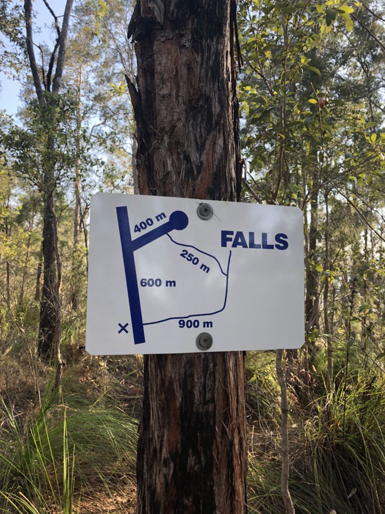 Sign direction to Windin Falls attached to a tree