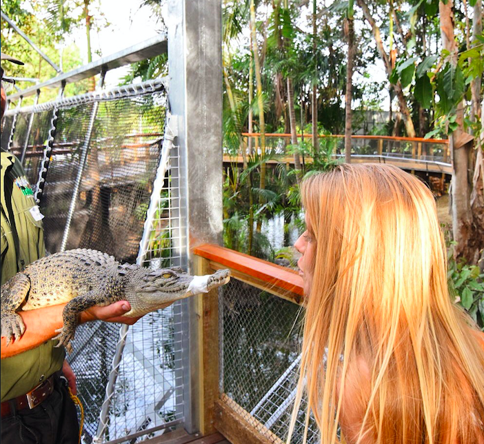 Girl kissing crocodile