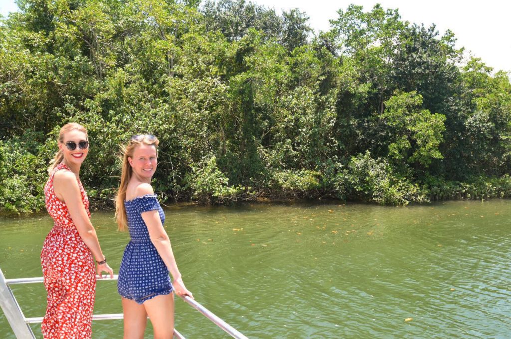 Two girls standing at the front of a boat at Daintree River Cruise